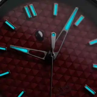 The maker’s low-light photograph of the dial and hands; not a measured lume test.