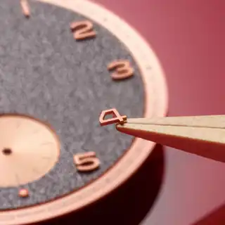 A close view of the dial texture, numerals and hands.