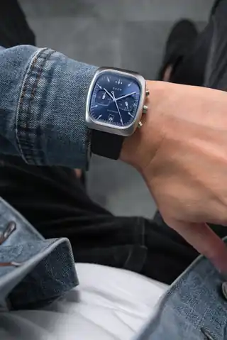 Retrograph Cobalt worn on the wrist in Brew’s photograph.