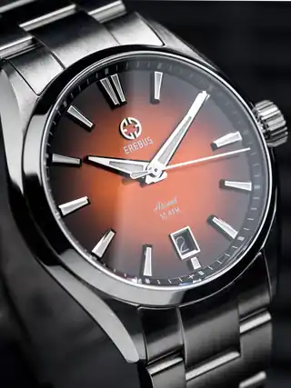 Orange Fumé dial on the O-style bracelet, photographed at an angle.