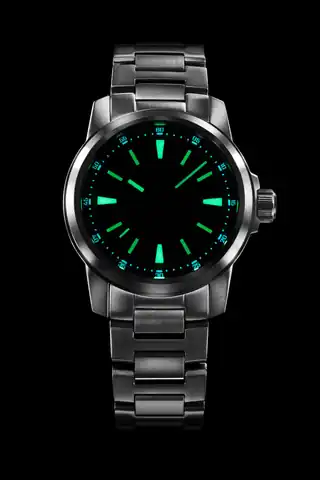 Maker photograph of the Midnight Blue dial with luminous markers lit.